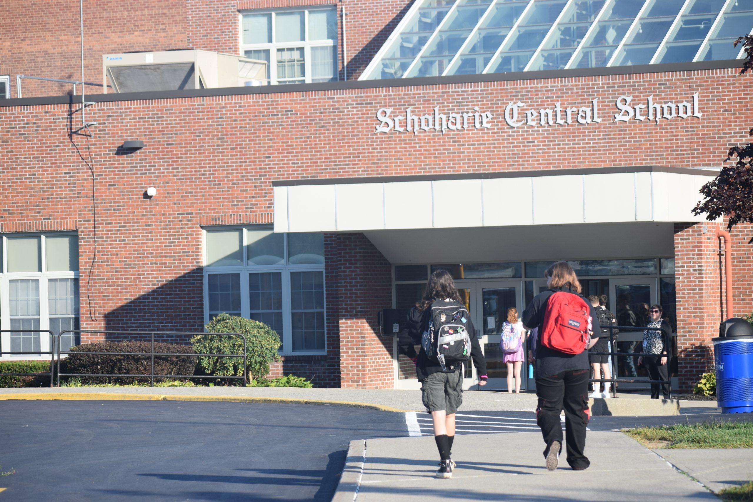 two students walk into school