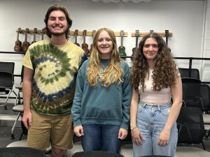 Three students stand