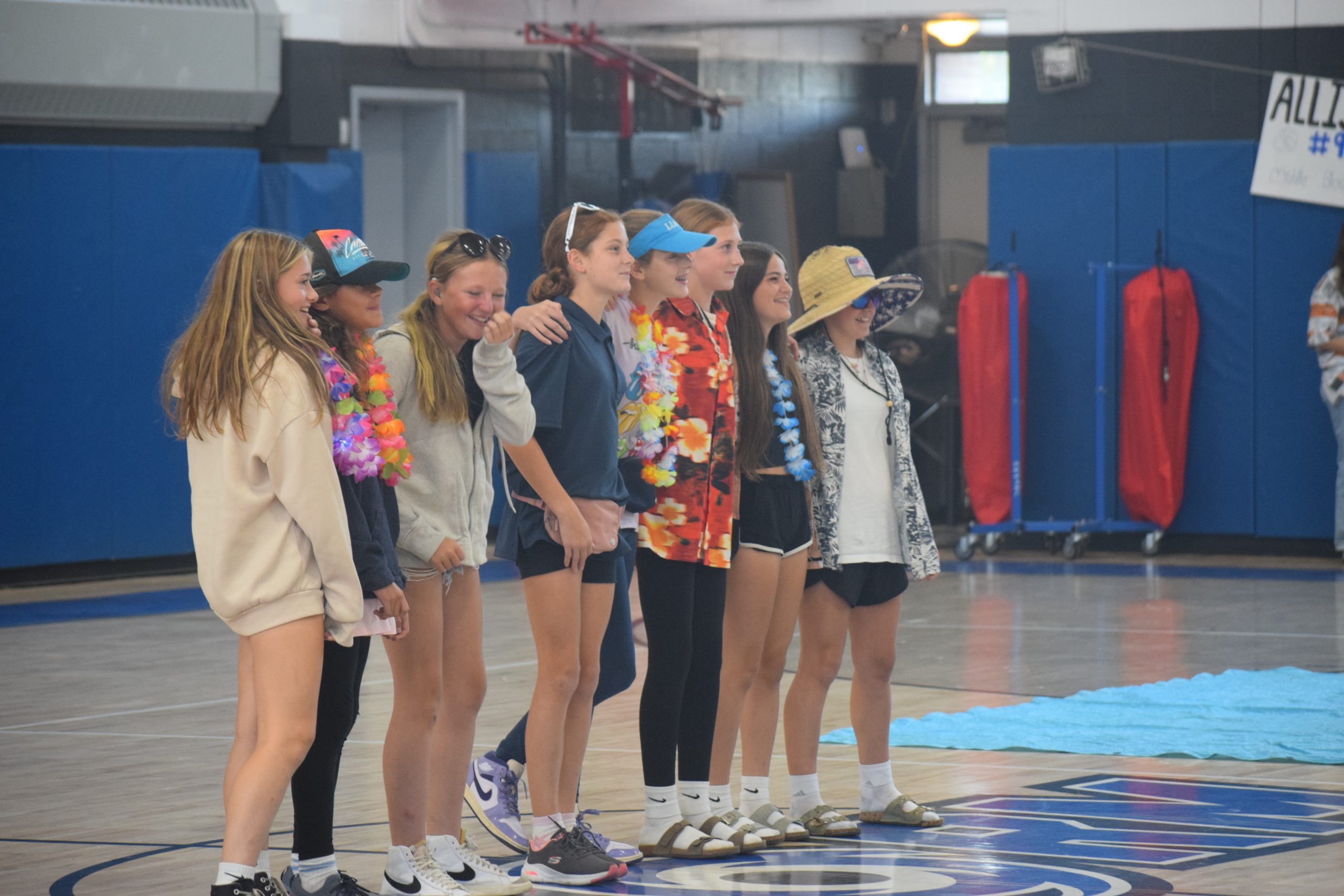 students stand in a gym