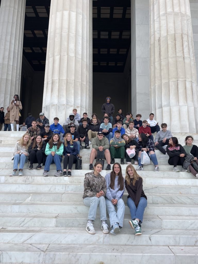 Students on steps in front of pillars