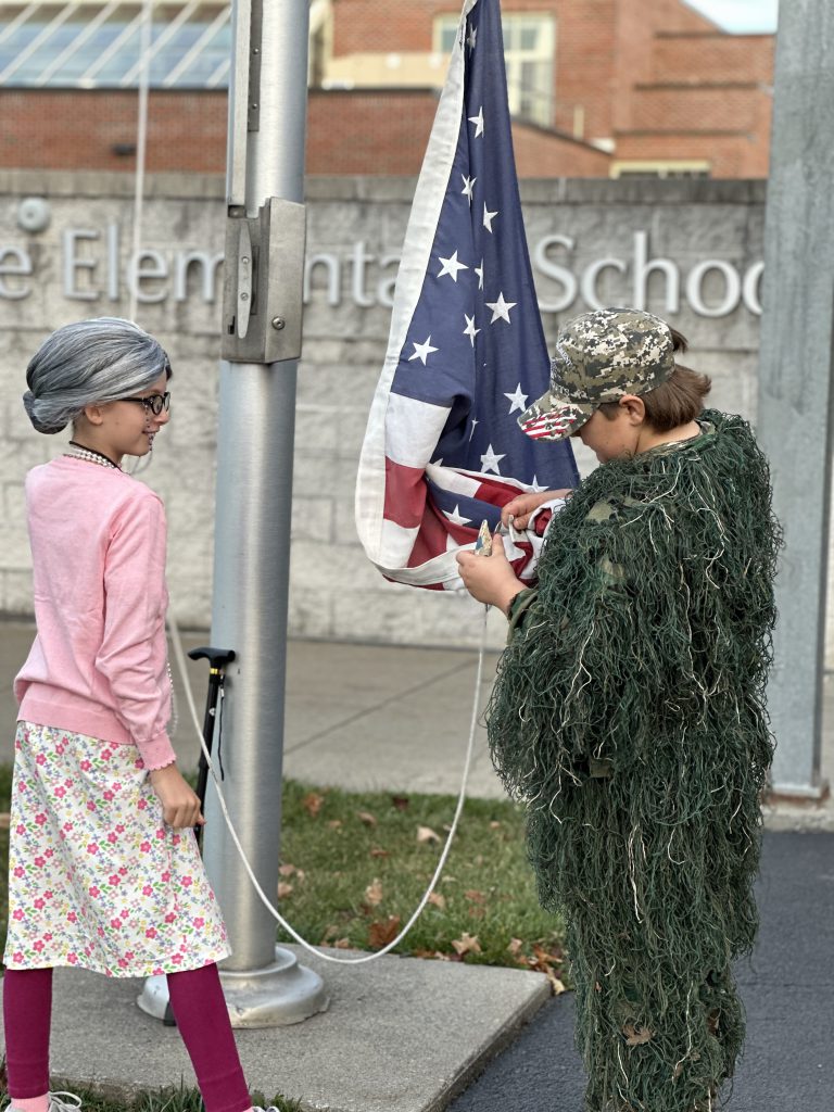 preparing a flag to be raised by students