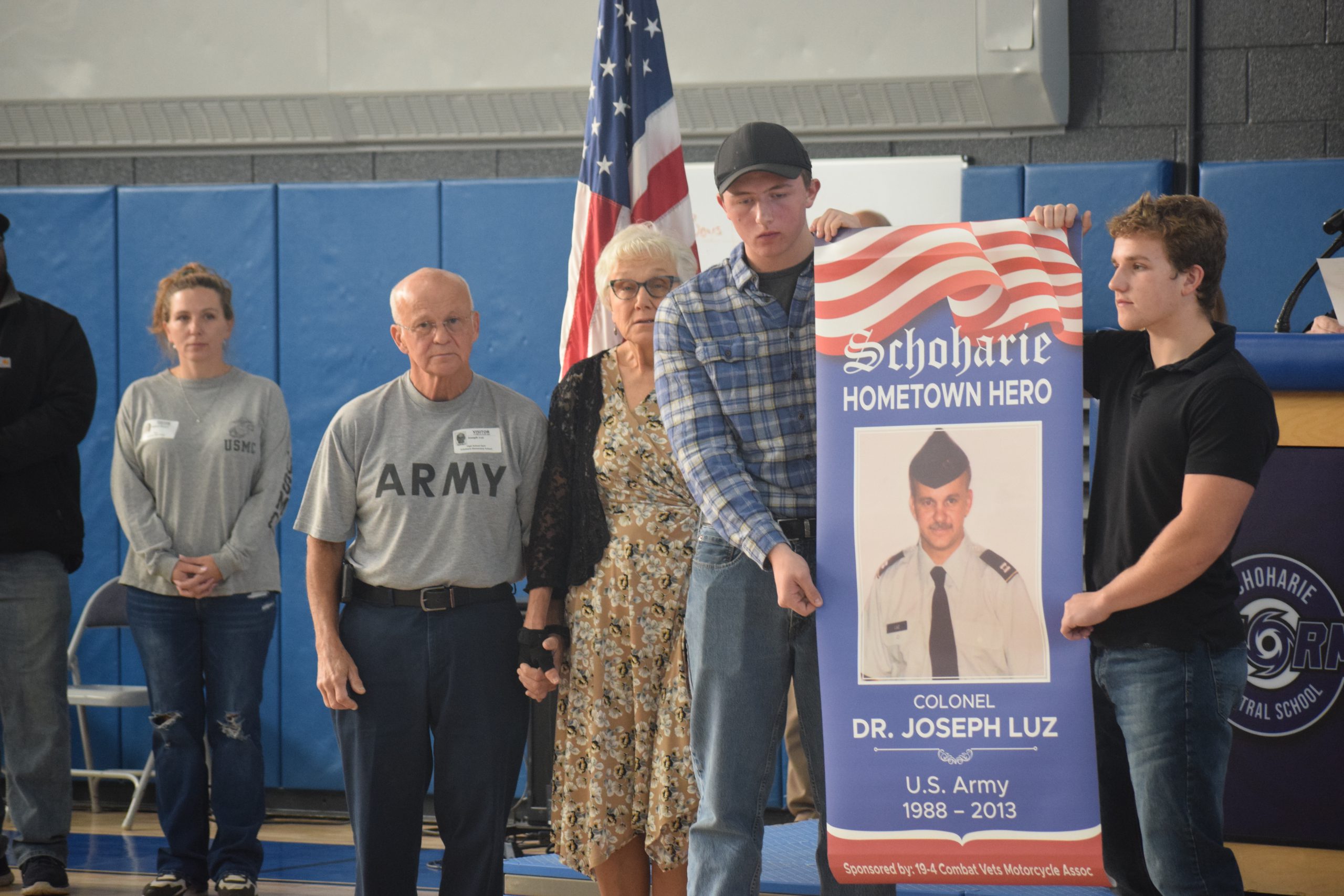 Two students hold a banner