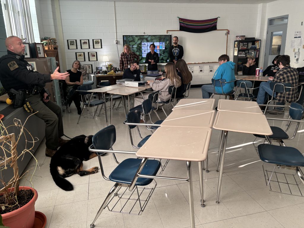 A K-9 officer speaks to a class