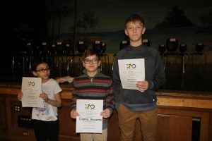 Three students stand 