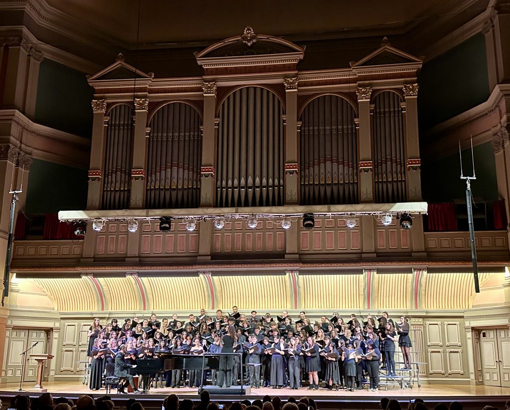 A choir sings on stage.