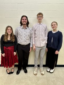 Four students stand