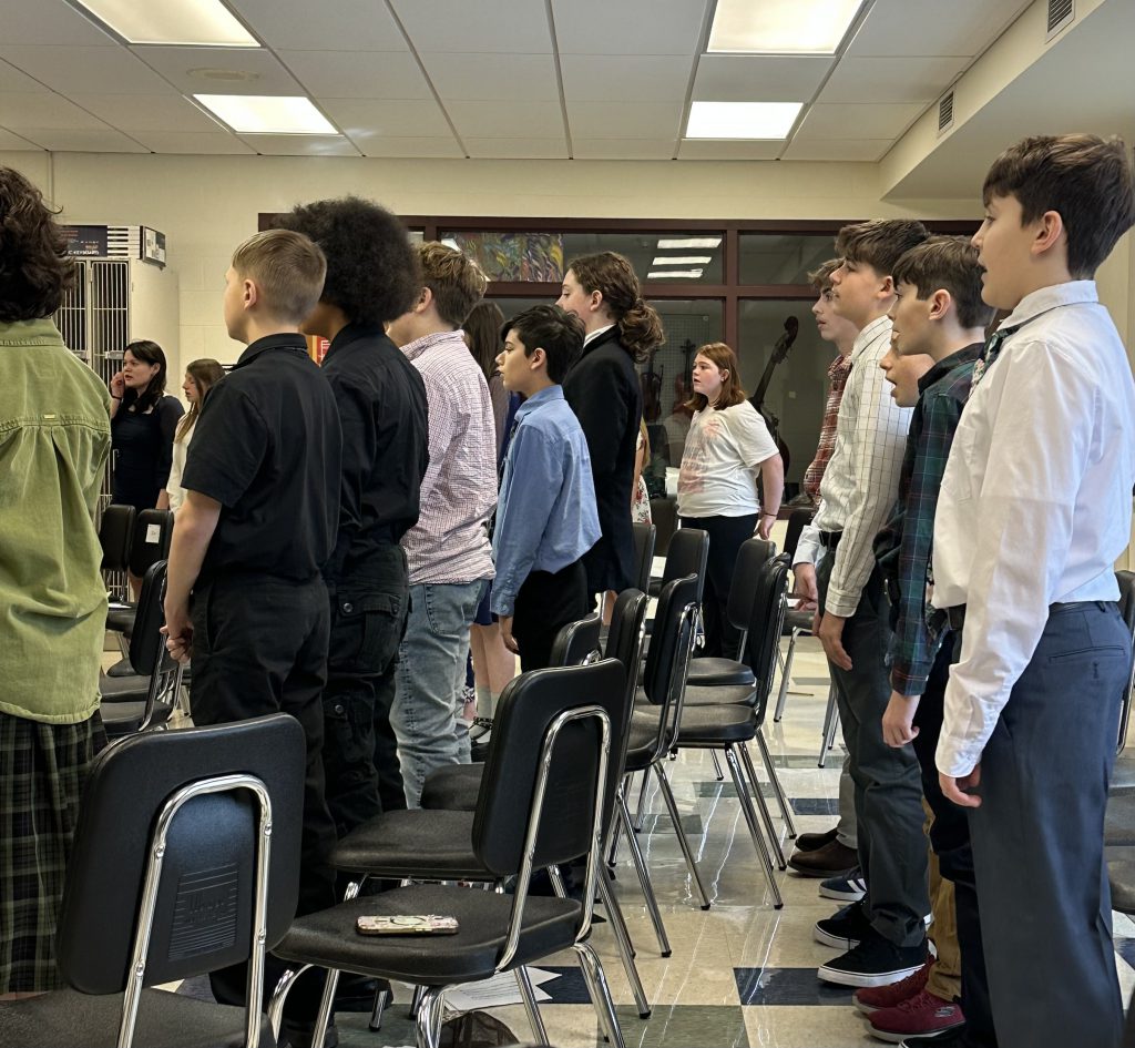 Students sing in a classroom