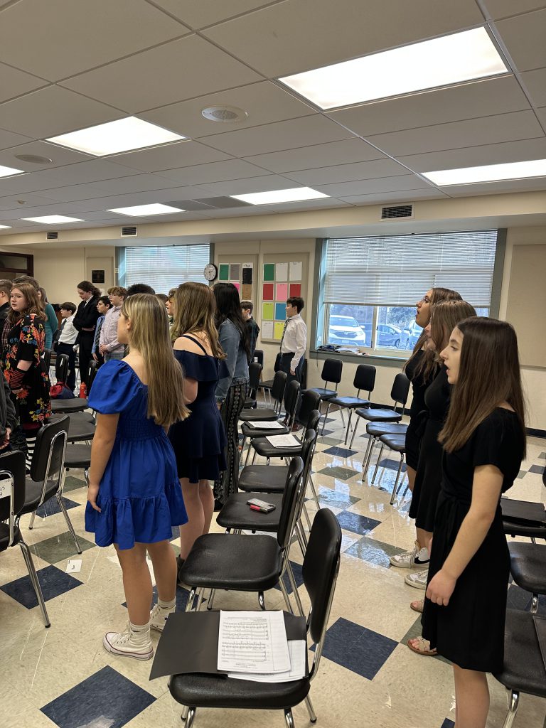 Students stand in a classroom